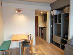 a kitchen and dining room with a table and chairs at CONDOR STUDIO BARILOCHE in San Carlos de Bariloche