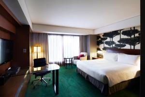 a hotel room with a bed and a desk and a television at InterContinental Seoul COEX, an IHG Hotel in Seoul