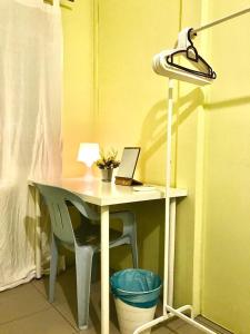 a desk with a laptop and a chair with a lamp at Once In Peninsula by Nestcove in Melaka