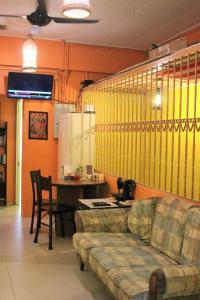 a living room with a couch and a table at Once In Peninsula Guesthouse by Nestcove in Melaka