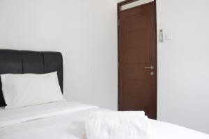 Ένα ή περισσότερα κρεβάτια σε δωμάτιο στο Compact and Minimalist 2BR Apartment at Gateway Pasteur By Travelio +8 φωτογραφίες