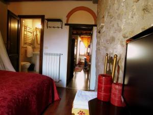 
a room with a door open and a bed in it at Guest House il Borgo di Sempronio in Semproniano
