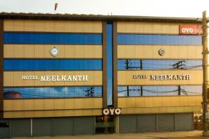 a building with a clock on the side of it at Hotel Neelkanth in Jabalpur