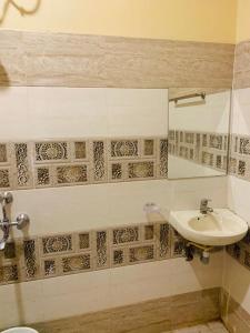 a bathroom with a sink and a toilet at Hotel Neelkanth in Jabalpur