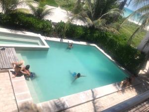 an overhead view of people in a swimming pool at Hotel La Casa Cielo in El Cuyo