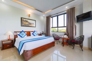 a bedroom with a large bed and a window at Quynh Mai Resort in Phu Quoc