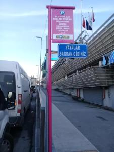 a street sign in a parking lot next to a van at Hotel The Pera Hill in Istanbul