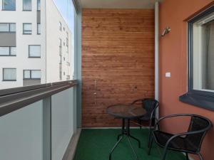 a small table and chairs in a room with a window at Kotimaailma Apartments Joensuu - Koulukatu 21 in Joensuu