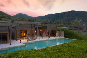 a house with a swimming pool in front of a house at Six Senses Con Dao - Turtle Island Paradise in Con Dao