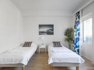 Ένα ή περισσότερα κρεβάτια σε δωμάτιο στο Kotimaailma Apartments Joensuu - Kalevankatu 36