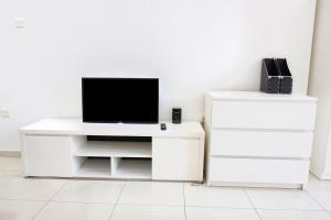 a white desk with a television on top of it at SHH - Furnished Studio in Spring Oasis, Silicon Oasis in Dubai