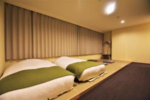 En eller flere senger på et rom på Randor Residence Tokyo Suites