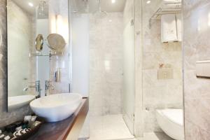 a white bathroom with a sink and a shower at The Haze Karaköy in Istanbul