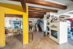 a living room with a fireplace and a dining room at B&B Punto Magico in Offagna
