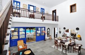 an open living room with a dining room and a house at Villa Blue Sapphire in Pefki Rhodes