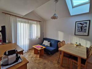 sala de estar con sofá azul y mesa en Appartements Wilma en Schladming
