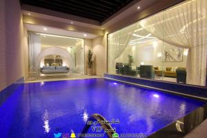 a swimming pool in a living room with at V1 Resort in Riyadh