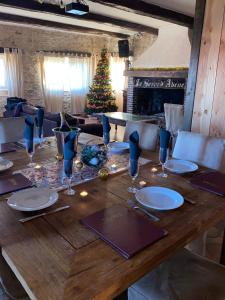 a wooden table with a christmas tree in the background at Domaine du Serre d'Avène in Saint-Christol-lès-Alès