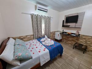 a bedroom with a bed and a television in it at Hotel Marajó - Turismo de Experiência in Soure