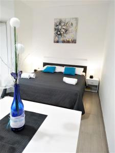 a bedroom with a bed with a blue vase at SeaEye Trogir in Trogir