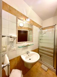 a bathroom with a sink and a shower at Hotel Berti in Assisi