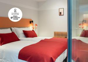 a bedroom with two beds with red and white sheets at Atlas Aparthotel in Piatra Neamţ