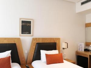 Voodi või voodid majutusasutuse Le Pietri Urban Hotel toas