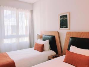 Voodi või voodid majutusasutuse Le Pietri Urban Hotel toas