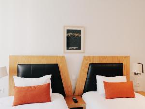 Voodi või voodid majutusasutuse Le Pietri Urban Hotel toas