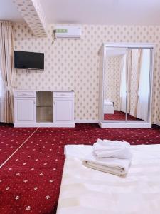 a bedroom with a large mirror and a bed at Sergeev Hotel in Mykolaiv