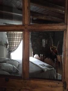 a glass cabinet with a bed in a room at La Peiro Douco in Roure Turin