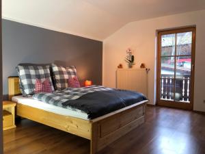 a bedroom with a bed and a window at Ferienhaus am Hocheck in Oberaudorf