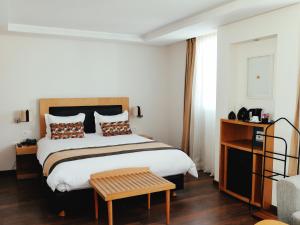 Voodi või voodid majutusasutuse Le Pietri Urban Hotel toas