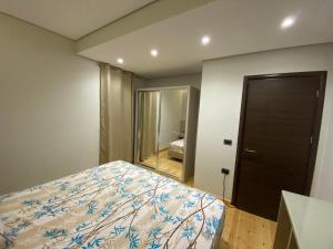 a bedroom with a bed and a large mirror at Villa Panorama - 3 Bedrooms Sea View - Free Parking in Sarandë