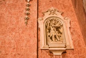 a statue of a woman on the side of a building at Masseria Spina Resort in Monopoli