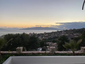 a view of the city and the ocean at sunset at Villa Panorama - 3 Bedrooms Sea View - Free Parking in Sarandë