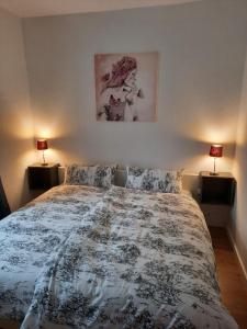 a bedroom with a large bed with two lamps at Sueños Apartment in Magdeburg