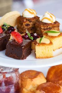 a plate of cakes and pastries with fruit on it at The Elms Hotel & Spa in Abberley