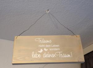 a sign hanging on the ceiling of a room at Vier Jahreszeiten Haus 3 Whg 24 in Großenbrode
