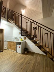 a kitchen with a staircase in a house at Вілла Джерело in Skhidnitsa