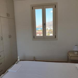 A bed or beds in a room at Agiassos Naxos Apartments