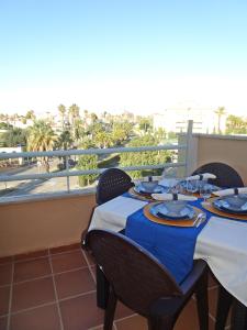 a table on a balcony with a view at GOLF Y MAR - Oliva Nova in Oliva