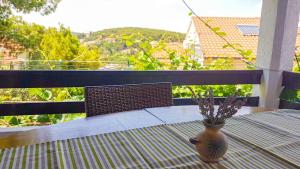 a vase sitting on a table on a balcony at Apartmani Tina in Jelsa