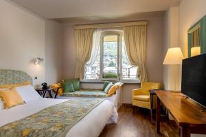Postel nebo postele na pokoji v ubytování Bijou Hotel