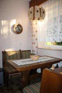 a dining room table with a basket on top of it at Haus Müller Adelheid in Hilders