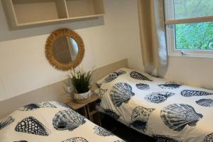 a bedroom with two beds and a mirror at Chalet in Renesse in Renesse
