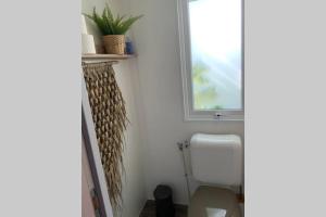 a bathroom with a toilet and a window at Chalet in Renesse in Renesse +14 photos
