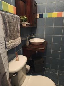 a bathroom with a white toilet and a sink at Hermosa Casa en San Carlos, Antioquia in San Carlos