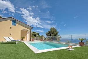 a swimming pool in the yard of a house at Luxury Bicocca - Mareri apartments in Costarainera