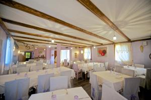 a dining room with white tables and white chairs at Agrimargherita in Caorle